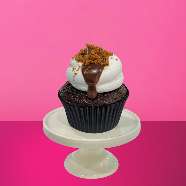 Chocolate cupcake topped with torched meringue, drizzled chocolate ganache, and Biscoff crumb, filled with creamy Biscoff spread.