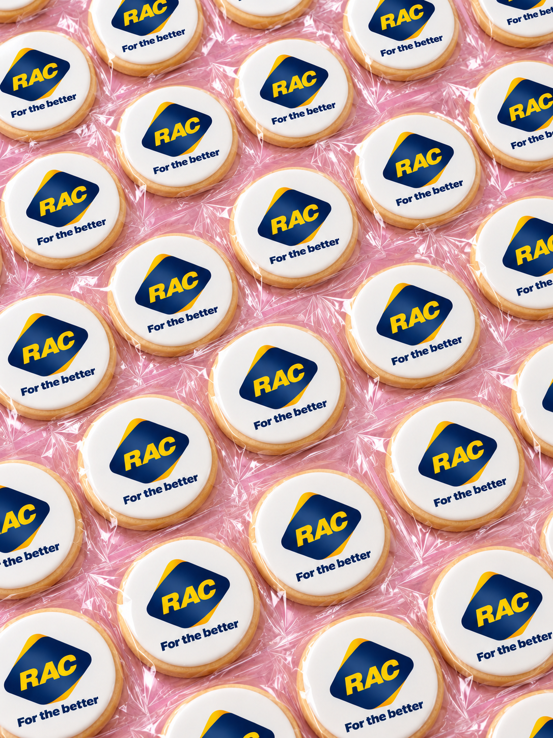 Individually wrapped round corporate logo cookies featuring the RAC logo on white edible icing, custom branded and freshly baked by Sugar Rush Bakery Perth.