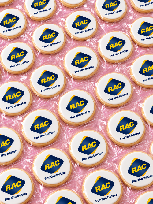 Individually wrapped round corporate logo cookies featuring the RAC logo on white edible icing, custom branded and freshly baked by Sugar Rush Bakery Perth.