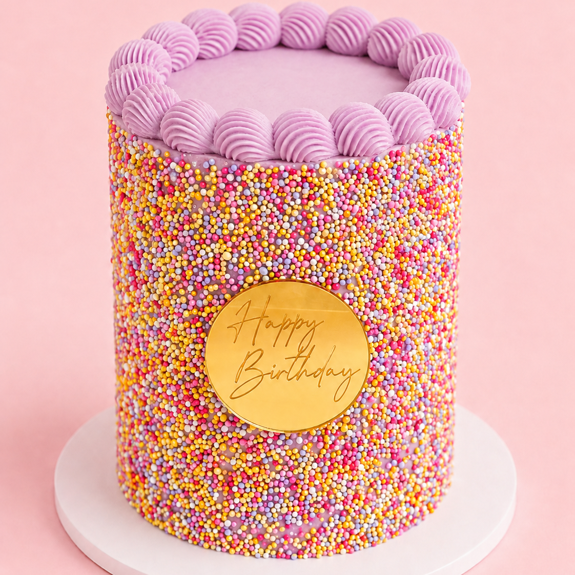 Dot Cake with colourful hundreds and thousands, pink shell piping and gold Happy Birthday plaque by Sugar Rush Bakery