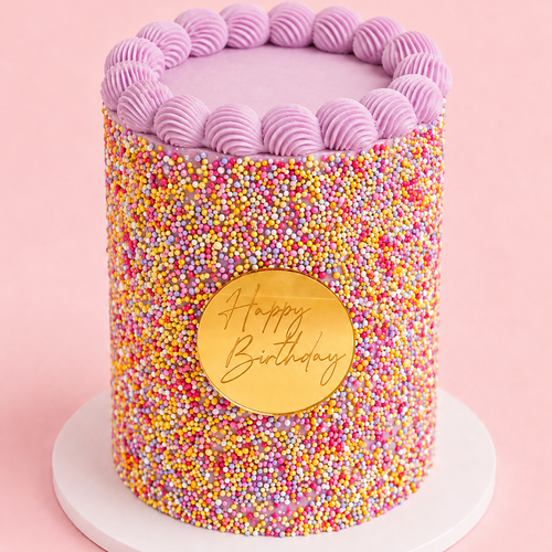 Dot Cake with colourful hundreds and thousands, pink shell piping and gold Happy Birthday plaque by Sugar Rush Bakery