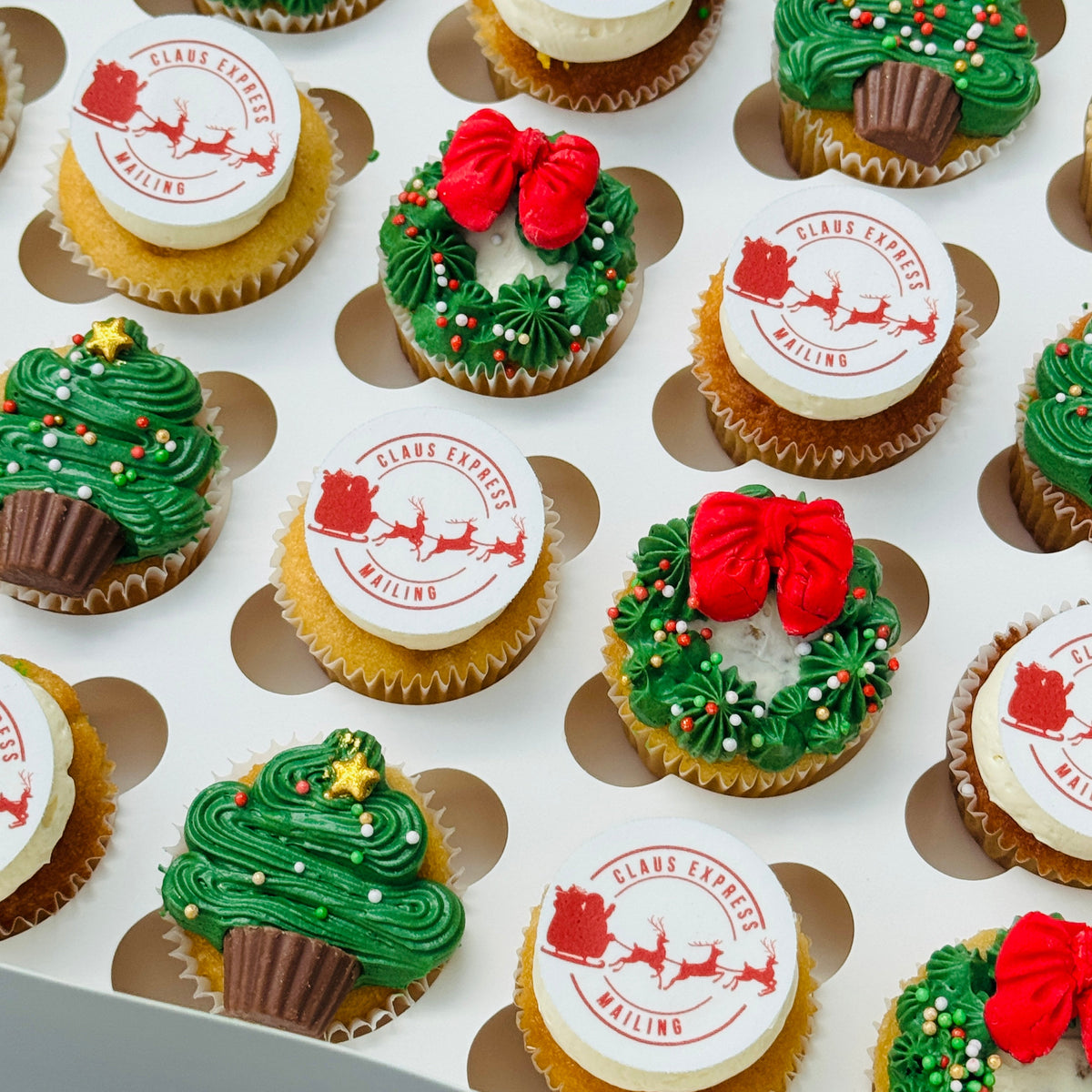 Assorted Christmas-themed cupcakes on a tray