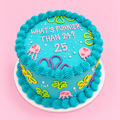 A round birthday cake decorated with bright turquoise frosting, piped scalloped edges, and underwater-themed icing details including jellyfish, seaweed, and the text 'WHAT'S FUNNIER THAN 24? 25' on top, shown on a pink background.