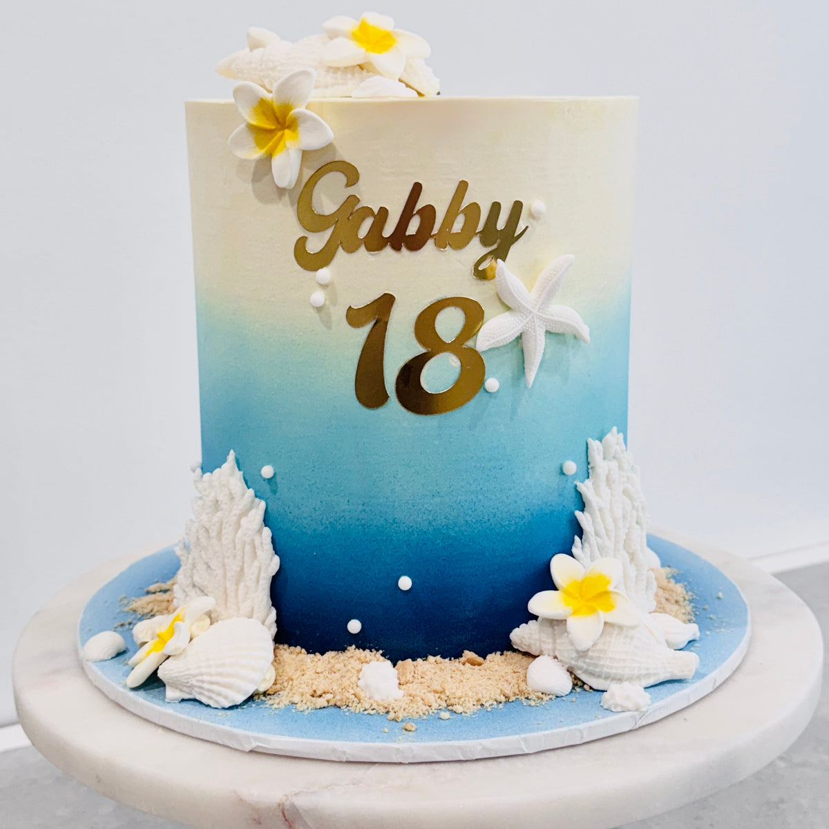 Beach themed cake, 18th birthday cake, and frangipani cake