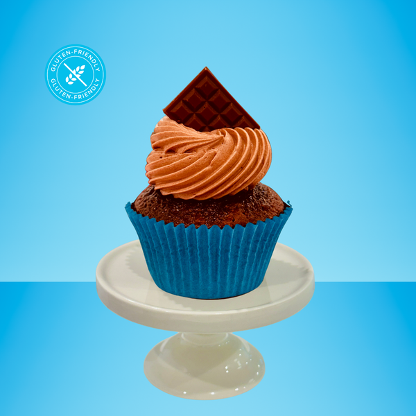 a gluten-friendly chocolate cupcake on blue background. 